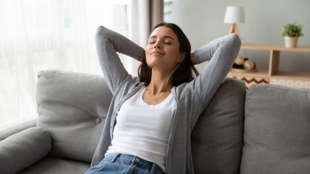 Frau beim Entspannen auf der Couch | Credit: iStock.com/fizkes