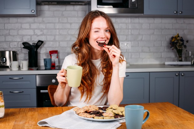 Frau beim Verzehr von Keksen und Milch | Credit: iStock.com/Iuliia Bondar