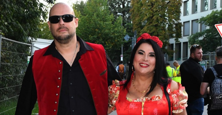 Iris Klein und Mister T beim Oktober fest. Beide tragen rote Tracht.