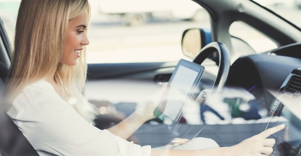 Junge Frau hinter dem Steuer eines E-Autos | Credit: iStock.com/vadimguzhva