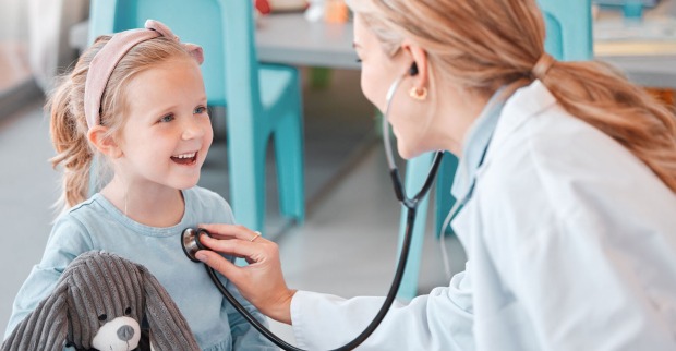 Ärztin untersucht ein junges Kind mit einem Stethoskop