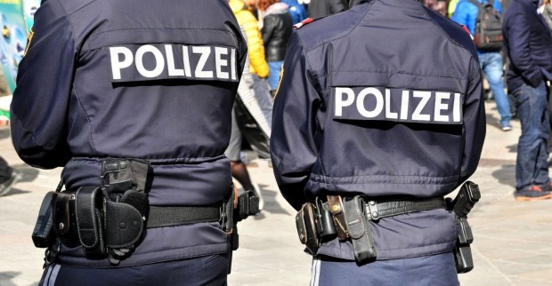 Zwei Polizisten in Montur stehen auf einer Straße