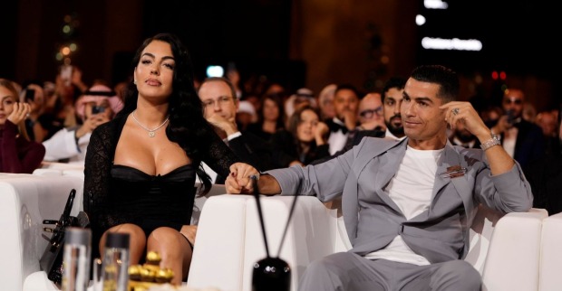Cristiano Ronaldo und Georgina Rodríguez sitzen bei einer Veranstaltung nebeneinander und halten Händchen/Alle Infos und Fotos zur Cristainao Ronaldo Hochzeit