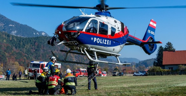 Polizeihubschrauber und Einsatzkräfte bei einer Suchaktion in bergigem Gelände