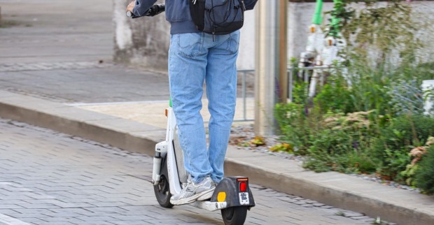 Jugendlicher fährt auf einem E-Scooter