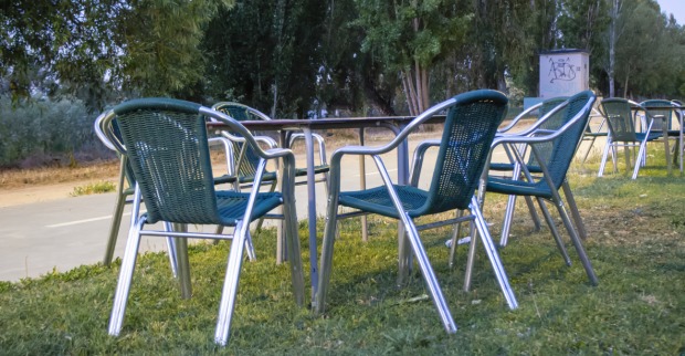 Tische und Stühle in einem Gastgarten